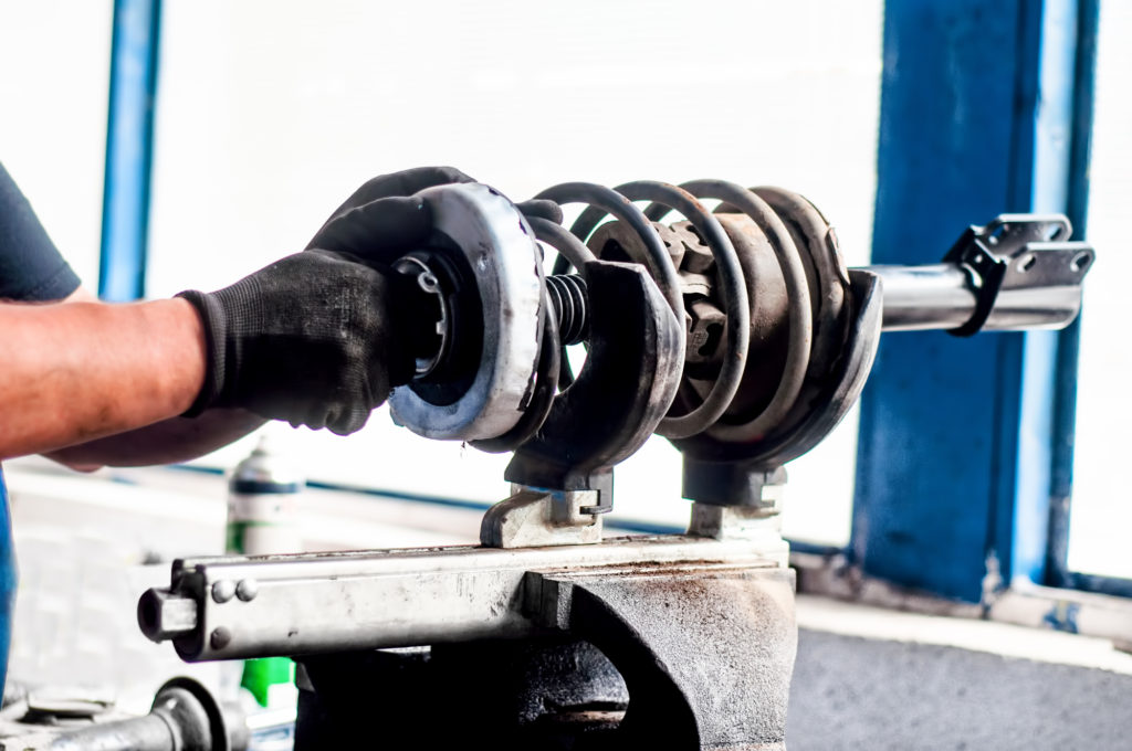 shock-absorber-being-adjusted-in-a-car-workshop